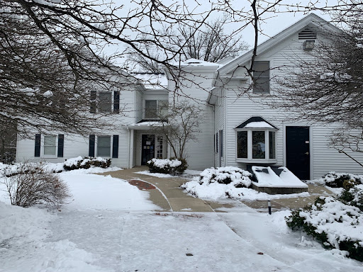 Features the Williamson House, a white house in a snowy scene. The walkway is cleared and inviting.