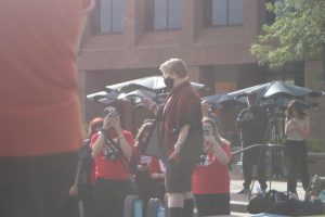 Chloe Ripoli, a sophomore political science and gender and sexuality studies major, addresses the crowd at a funeral-themed protest, Aug. 27, 2025.